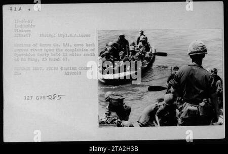 Marines of Bravo Company 1/1, under Operation Early, retreat across the river after finishing the mission held 12 miles south of Da Nang on March 25, 1967. This photograph shows military activities during the Vietnam War conducted by the 1st Marine Division. Stock Photo