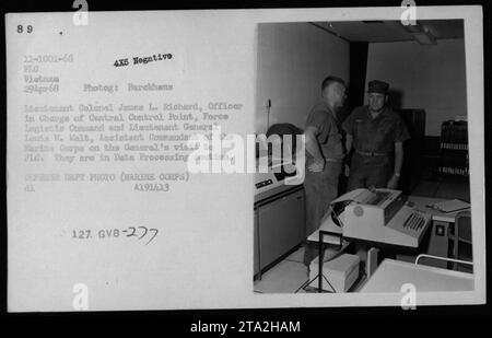 Lieutenant General Lewis W. Walt and Lieutenant Colonel James L. Richard were photographed on April 29, 1968, during General Walt's visit to the Force Logistie Command (FLC) in Vietnam. The image shows them in the Data Processing section, with Lieutenant Colonel Richard in charge of the Central Control Point. This photo is a Defense Department photograph taken by Marine Corps personnel. Stock Photo