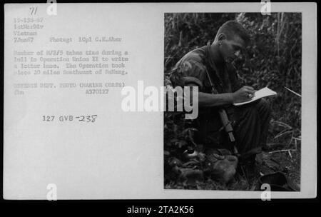 Marine Cpl. C.E. Aker, a member of M/3/5, takes a break during Operation Union II to write a letter home. The operation occurred approximately 20 miles Southwest of Dallang, Vietnam. This photograph was taken on June 7, 1967, by the Defense Department and is part of the Marine Corps archives. Stock Photo