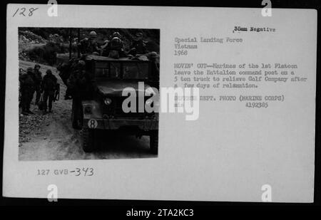 Marines of the 1st Platoon leave the Battalion command post on a 5 ton truck to relieve Golf Company in Vietnam. The photograph from 1968 shows various vehicles including jeeps, trucks, and dune buggies. This image captures a moment during the movement of troops and resources in the war. Stock Photo