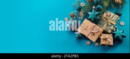 Christmas background. Gift boxes tied ribbons and christmas decorations on turquoise background. Stock Photo