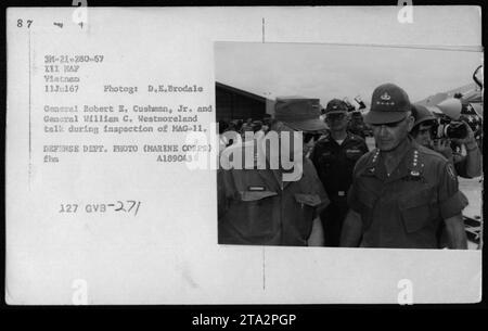 General Robert B. Cushman, Jr. and General William C. Westmoreland during an inspection of MAG-11. The photo was taken on July 11, 1967, by D.E. Brodale. It captures a conversation between the two officers as they discuss military activities in Vietnam. This image showcases the involvement of high-ranking officials during the Vietnam War. Stock Photo