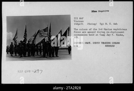 Members of the 3rd Marine Amphibious Force stand in formation during re-deployment ceremonies at Camp Jay K. Books, Vietnam on April 14, 1971. These soldiers can be seen wearing the distinctive colors of their unit. The photograph captures a moment of military activity during the Vietnam War. Defining the Defense Department image number as A800149. Stock Photo