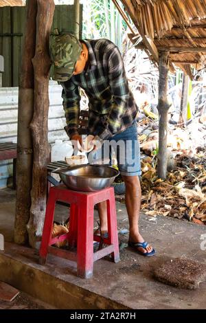 Cutting open coconuts. Vietnam Stock Photo