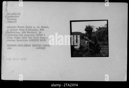 Private First Class I. E. Grane, an gunner from G Company, 2nd Battalion, 9th Marines, cleans his magazine after a firefight with the Viet Cong during Operation HARVEST MOON in Vietnam on December 12, 1965. This photo captures the soldier's attention to detail and commitment to operational readiness. Stock Photo