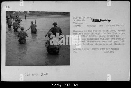 U.S. Marines from the Second Battalion, Fourth Marines, make their way through the Cua Viet river on May 3, 1968. The marines are moving ashore from 'Mike' boats to search for remaining North Vietnamese Army soldiers and equipment in the destroyed village of Dai Do after three days of fighting. This photo was taken by Ife Thurston Bachtel of the Defense Department. Stock Photo