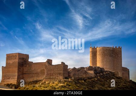 General view of Jumilla Castle, Murcia, Spain, with tower and medieval walls and blue sky Stock Photo