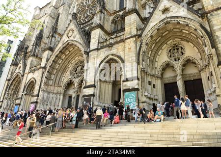 New York, USA - May 25, 2018: People near The Cathedral Church of St. John the Divine in New York. Stock Photo