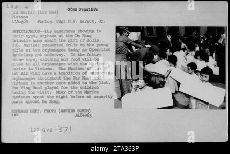 US Marines from the 1st Air Wing participate in Operation Handclasp by presenting dolls to orphans at the Da Nang Catholic home in Vietnam on August 17, 1965. This event marked the beginning of the distribution of toys, clothing, and food to all orphanages within the Marines' sector. The Marines have a long-standing tradition of supporting orphanages in the Far East, and Vietnam became part of that effort. The Wing Band also entertained the children during the visit. Defense Department Photo (Marine Corps). Stock Photo