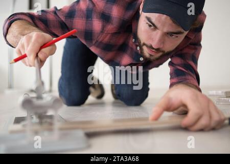 a workman cutting ceramic tiles Stock Photo