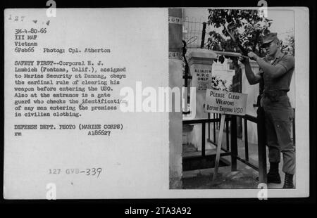 Marine corporal E. J. Lambich from Fontana, California, assigned to Marine Security at Danang, is following safety protocols by clearing his weapon before entering the USO. A gate guard is stationed at the entrance to check the identification of anyone in civilian clothing entering the premises. This photograph was taken on February 6, 1966. Stock Photo