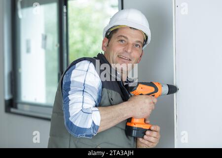 builder or homeowner using an electric drill Stock Photo