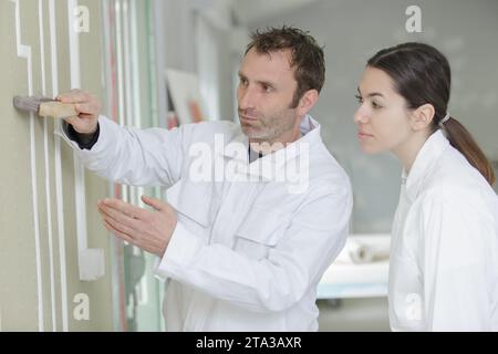 female apprentice decorator in training Stock Photo