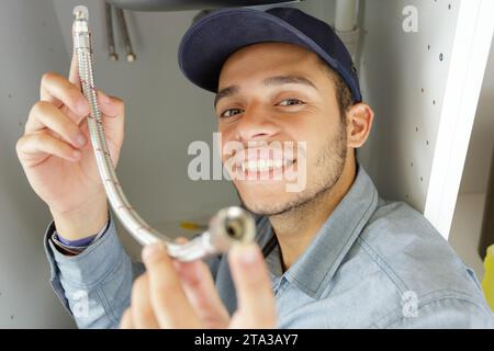 male plumber fixing sink pipe Stock Photo