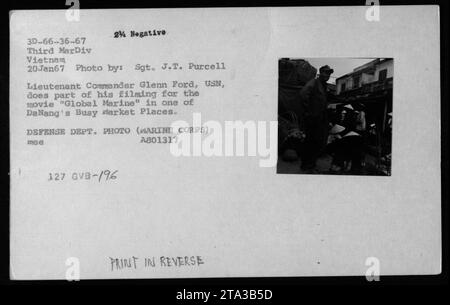 Lieutenant Commander Glenn Ford, USN, observes a convoy passing through ...