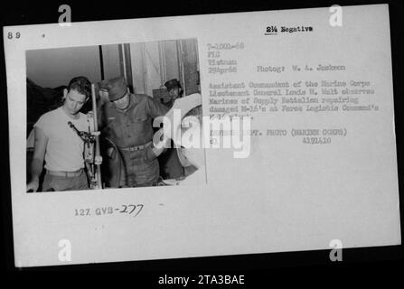 Lt Gen Lewis W Walt, Assistant Commandant of the Marine Corps, is seen observing Marines of Supply Battalion as they repair a damaged 1-16'e at the Force Logistic Command's H-16 plant in Vietnam on April 29, 1968. The photo was taken by W. A. Jackson, a Defense Department photographer. Stock Photo