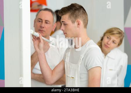 young man painting with brush Stock Photo