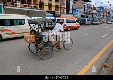 Mae Sai, Thailand - August 04 2012: Thai man riding a rickshaw in the street od Mae Sai, a town in the North of Thailand, on the Myanmar border. Stock Photo