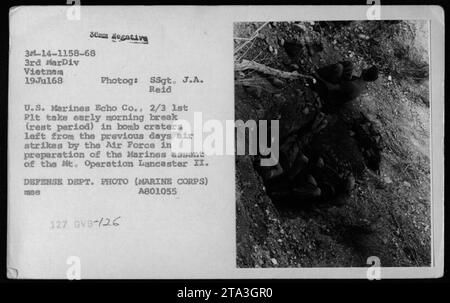 Marines from Echo Company, 2/3, 1st Platoon, take a break in bomb craters created by the Air Force's previous day's airstrikes during Operation Meade River on July 19, 1968. The photograph, taken by SSgt. J.A. Reid, showcases the rest period of the Marines before their ascent of Mt. Operation Lancaster II. Department of Defense photo, Marine Corps. Stock Photo