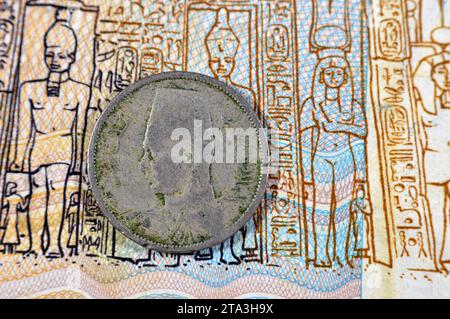 round metal two 2 Egyptian milliemes series 1938 AD 1357 AH features bust of King Farouk I of Egypt on obverse side and value and date on reverse side Stock Photo