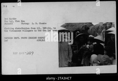 American Marines from 2/4, VMF-214, distribute clothing to Vietnamese villagers in the Chu Lai area on June 26, 1965. The photo captures a People to People interaction, highlighting the involvement of the Marines in providing aid and support to the local civilian population during the Vietnam War. Stock Photo