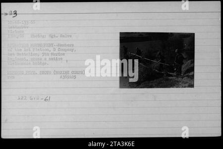 1st Platoon, D Company, of the 5th Marine Regiment, navigates a native Vietnamese bridge during Operation Montgomery. The photo was taken on May 13, 1966, by Sgt. Salve. This image is part of a collection documenting American military activities during the Vietnam War. Stock Photo