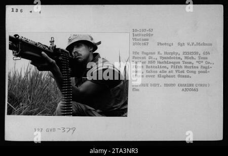 A Marine Sergeant named Eugene E. Murphy, serving as a team leader of the M60 Machinegun Team, 'C' Company, 1st Battalion, Fifth Marine Regiment of the 1st Marine Division, takes aim at Viet Cong positions using a US weapon over Elephant Grass during the Vietnam War on October 24, 1967. The photograph was taken by Sergeant W.F. Dickman. Stock Photo