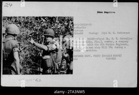 First Lt. R. T. Rohweller, a company commander with the 9th Marine Regiment, briefing his men on top of Hill 764 during a combat operation in Vietnam. Photograph taken on January 29, 1969. Stock Photo