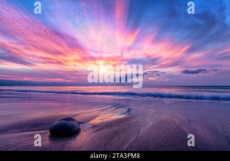 A Beautiful Ocean Sunset With A Wave Breaking On Shore High Resolution Stock Photo