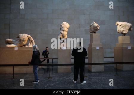 Visitors view Elgin marbles also known as the Parthenon marbles, at the British Museum, London following a diplomatic row between UK and Greece. Greek Prime Minister Kyriakos Mitsotakis was due to meet British Prime Minister Rishi Sunak, cancelled a planned wide-ranging meeting with his Greek counterpart Kyriakos Mitsotakis over a diplomatic row the Parthenon marbles. The marbles are a collection of Ancient Greek sculptures from the Acropolis in Athens and were removed from the Parthenon in the early 19th century by Thomas Bruce, the 7th Earl of Elgin and then-British ambassador to the Ottoman Stock Photo