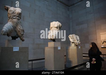 London, UK. 28th Nov, 2023. A visitor views Elgin marbles also known as the Parthenon marbles, at the British Museum, London following a diplomatic row between UK and Greece. Greek Prime Minister Kyriakos Mitsotakis was due to meet British Prime Minister Rishi Sunak, cancelled a planned wide-ranging meeting with his Greek counterpart Kyriakos Mitsotakis over a diplomatic row the Parthenon marbles. The marbles are a collection of Ancient Greek sculptures from the Acropolis in Athens and were removed from the Parthenon in the early 19th century by Thomas Bruce, the 7th Earl of Elg Stock Photo