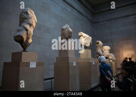 Visitors view Elgin marbles also known as the Parthenon marbles, at the British Museum, London following a diplomatic row between UK and Greece. Greek Prime Minister Kyriakos Mitsotakis was due to meet British Prime Minister Rishi Sunak, cancelled a planned wide-ranging meeting with his Greek counterpart Kyriakos Mitsotakis over a diplomatic row the Parthenon marbles. The marbles are a collection of Ancient Greek sculptures from the Acropolis in Athens and were removed from the Parthenon in the early 19th century by Thomas Bruce, the 7th Earl of Elgin and then-British ambassador to the Ottoman Stock Photo