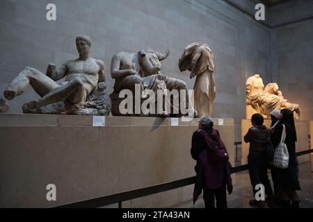 Visitors view Elgin marbles also known as the Parthenon marbles, at the British Museum, London following a diplomatic row between UK and Greece. Greek Prime Minister Kyriakos Mitsotakis was due to meet British Prime Minister Rishi Sunak, cancelled a planned wide-ranging meeting with his Greek counterpart Kyriakos Mitsotakis over a diplomatic row the Parthenon marbles. The marbles are a collection of Ancient Greek sculptures from the Acropolis in Athens and were removed from the Parthenon in the early 19th century by Thomas Bruce, the 7th Earl of Elgin and then-British ambassador to the Ottoman Stock Photo