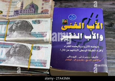Cairo, Egypt, November 21 2023: Stacks of Egypt money banknote bills EGP LE thousands of Pounds currency banknotes bill, and The Arabic version of Ric Stock Photo