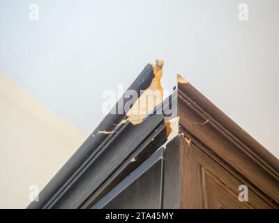 corner of the cabinet is broken. Crack in a wooden cabinet. Breakage ...