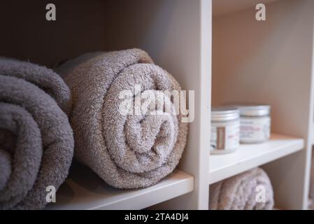 Luxurious and Elegant Bathroom Towels Displayed on Neatly Arranged Shelf in Relaxing Atmosphere Stock Photo