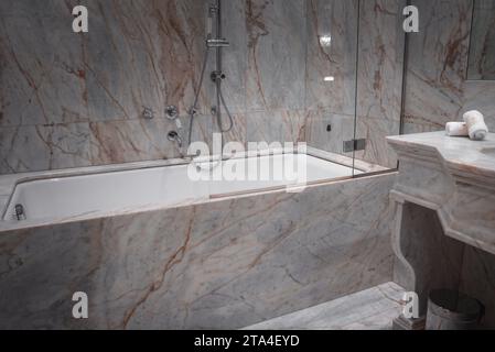 Luxurious marble bathroom with white bathtub and shower in Venice, Italy. Stock Photo