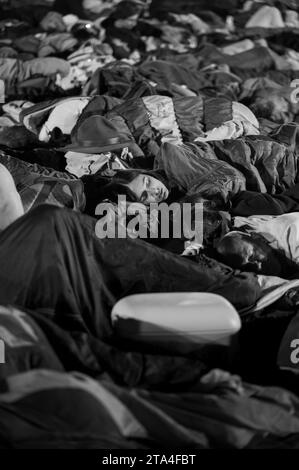 Young people sleeping at night in Parque Tejo – Campo da Graça. World Youth Days 2023 in Lisbon, Portugal. Stock Photo