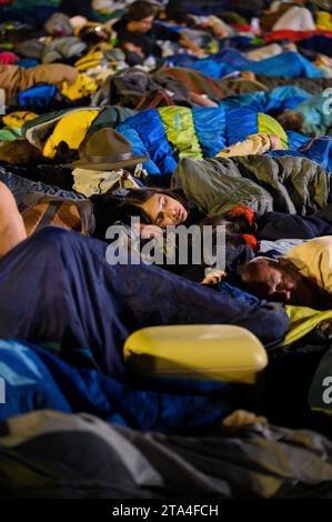 Young people sleeping at night in Parque Tejo – Campo da Graça. World Youth Days 2023 in Lisbon, Portugal. Stock Photo