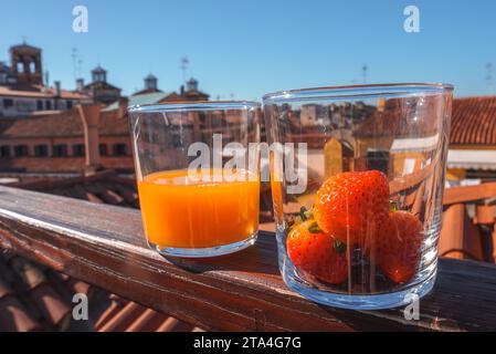 Venetian Style Balcony with Fresh Orange Juice and Strawberries in Luxury Setting Stock Photo