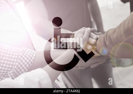 Inclusive workplace culture. International symbol of access. People holding hands together, closeup Stock Photo