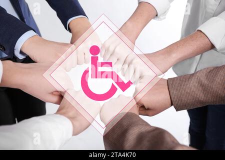 Inclusive workplace culture. International symbol of access. People holding hands together, closeup Stock Photo