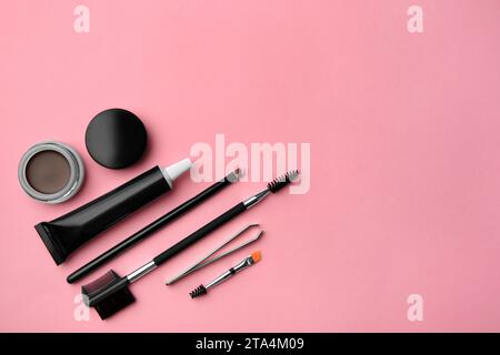 Flat lay composition with eyebrow henna and tools on pink background. Space for text Stock Photo