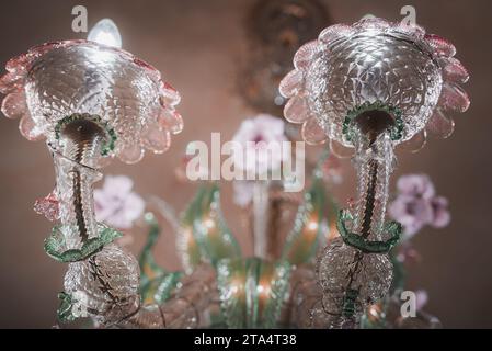 Exquisite Pink and Clear Glass Chandelier Adorned with Flowers in Luxurious Venetian Interior Stock Photo