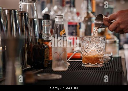 Bartender pouring drink into martini glass in luxury Venetian bar - Venice collection. Stock Photo