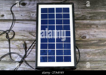 A solar panel, a device that converts sunlight into electricity by using photovoltaic (PV) cells which made of materials that generate electrons when Stock Photo
