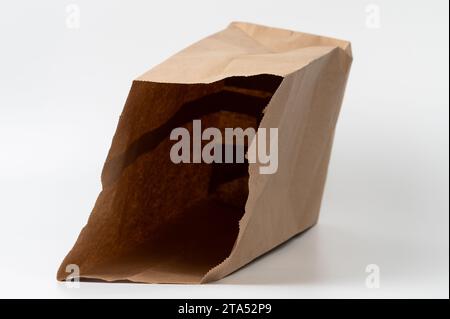 Open laying paper bag close up view isolated on white studio background Stock Photo