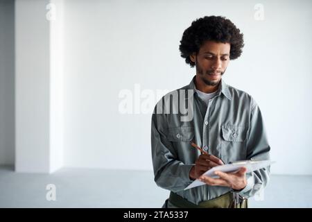 Foreman taking notes when inspecting construction site Stock Photo