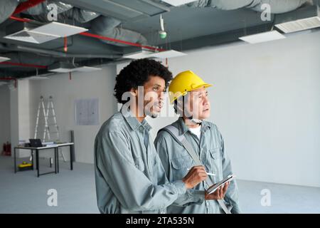 Foreman and head engineer inspecting construction site Stock Photo