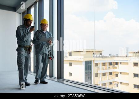 Engineer and contractor managing work at construction site Stock Photo